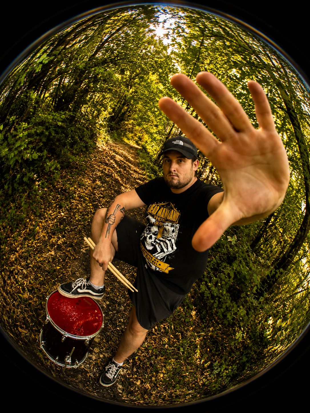Steve, drummer of SelfMind, standing over his snare drum in the woods
